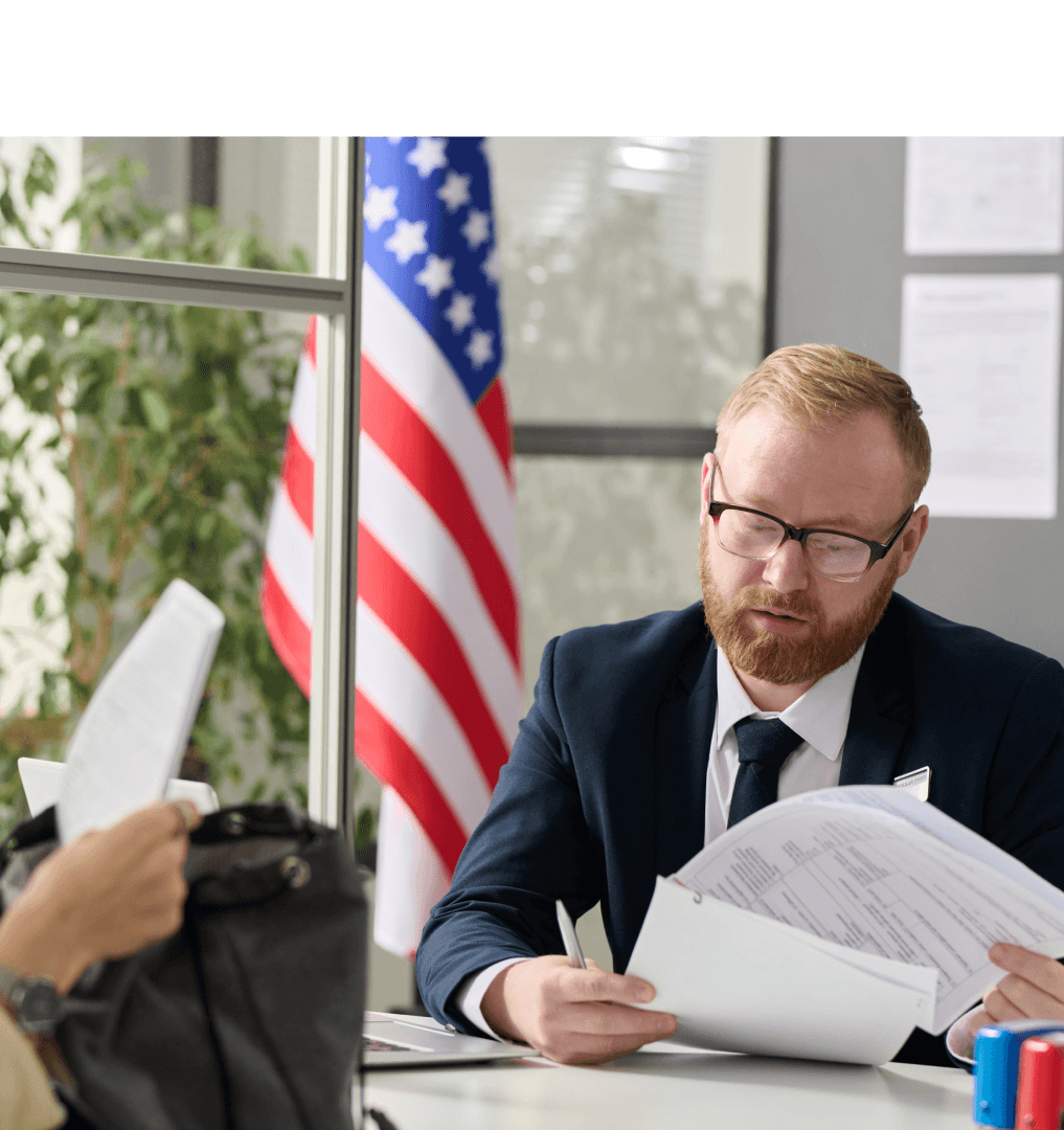 Immigration lawyer at desk with American flag