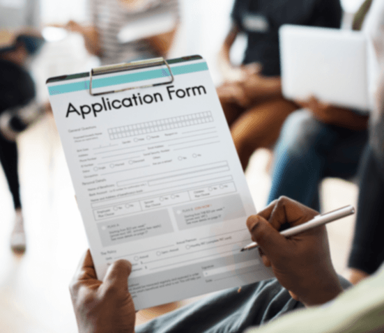 Person filling out application form