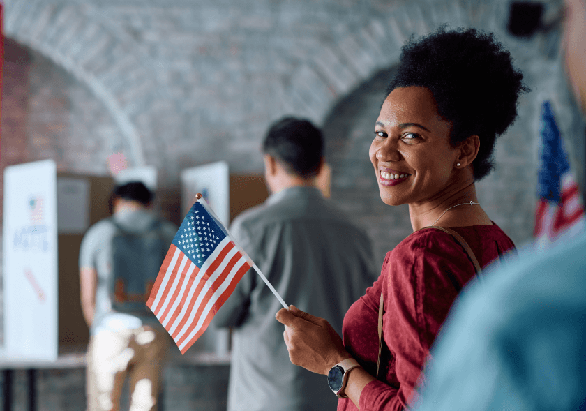 Woman holding American flag during naturalization ceremony